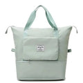 Bolso viajero plegable verde menta con bolsillo frontal y asas